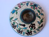 a picture of a ceramic bowl with a flower design on it
