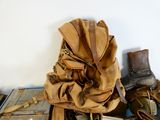 a pile of shoes and a backpack sitting on a table