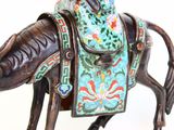 a statue of a horse with a saddle on it ' s back