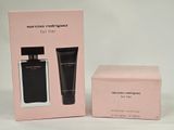 a pink box with two bottles of perfume next to a pink box