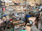 a room filled with lots of tools and a brick wall