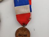 three medals and a clock on a table with a clock in the background