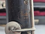 a close up of a musical instrument with a case in the background