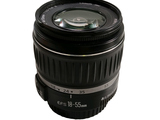 a camera lens sitting on top of a white surface