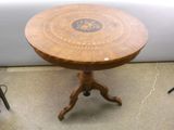 a wooden table with a circular top on a stand