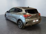 the rear end of a silver car parked in a showroom