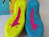 a pair of colorful shoes sitting on top of a white surface