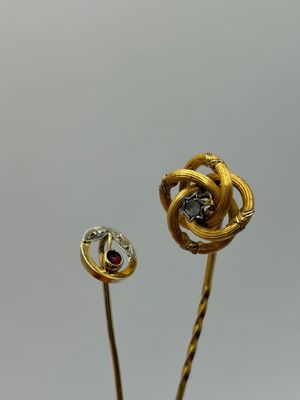 pair of gold and diamond flower broochers on a stick