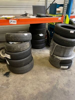 several tires are stacked on a shelf in a warehouse