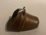 a small brown shoe that is on a white surface