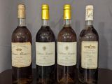 three bottles of wine sit on a table in front of a wall