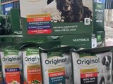 many bags of dog food sitting on a table
