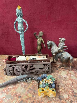 several figurines are sitting on a table next to a red wall