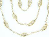 a close up of a gold necklace and bracelet set