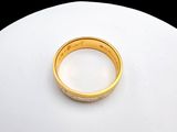 a gold ring sitting on top of a white plate
