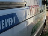a blue and white sign on the side of a white van