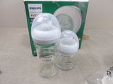 two baby bottles sitting next to each other on a table