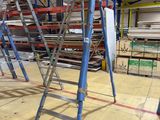many ladders that are sitting in a warehouse