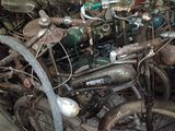 a lot of old bikes that are sitting in a garage