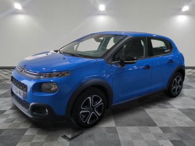 a blue citrole is parked in a large room