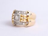 an image of a gold and diamond ring on a white surface