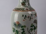 two vases that are sitting side by side on a white surface