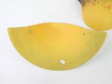 two pieces of fruit sitting on a table next to each other