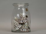 a glass jar with shells inside of it on a table