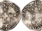 a silver coin with a cross on the front and a crown on the back