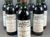 four bottles of wine are lined up on a table