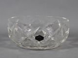 a close up of a clear glass bowl with a black diamond in the center