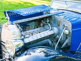 a blue car that is parked in the grass