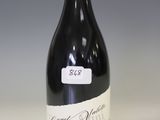 a bottle of wine that is sitting on a table
