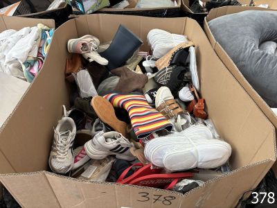 a cardboard box filled with shoes and other items