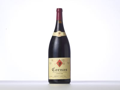 a bottle of red wine sitting on top of a table