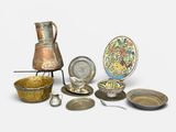 many different types of silverware on a white surface