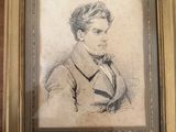 a drawing of a man in a suit and tie in a gold frame