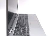 a silver laptop with a black keyboard on a white surface