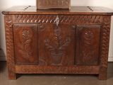 a wooden chest with a clock on top of it