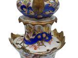 a blue and white vase sitting on top of a white plate