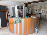 a picture of a woman sitting at a counter in a kitchen