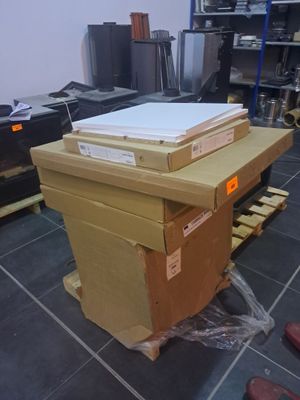 a stack of boxes sitting on top of a wooden table
