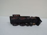a toy train on a white surface with a white background