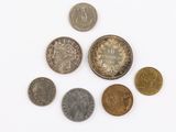 a lot of coins that are on a white surface