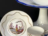 two cups and a saucer sitting on a table