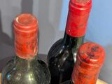 three bottles of wine sitting on a table next to each other