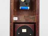 a small wooden box with a clock inside of it