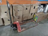 a fork lifter that is sitting in front of a bunch of boxes