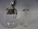 a small glass pitcher next to a small glass container