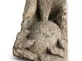 statue of an angel on a rock on a white background